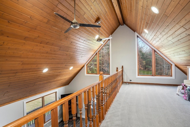 hallway featuring wood ceiling, a healthy amount of sunlight, and vaulted ceiling with beams