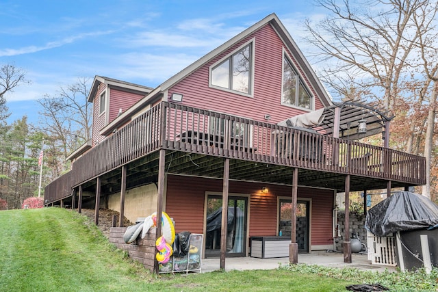 back of property featuring a deck and a yard