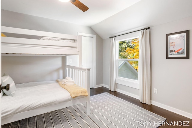 unfurnished bedroom featuring dark hardwood / wood-style flooring, ceiling fan, a closet, and lofted ceiling