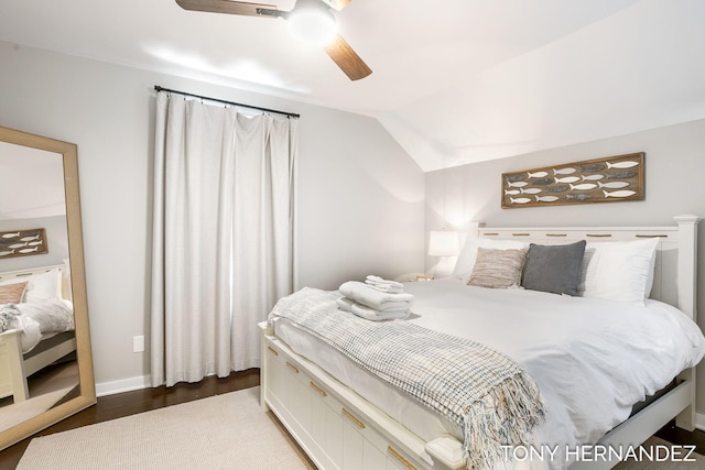 bedroom featuring ceiling fan, dark wood-type flooring, and vaulted ceiling