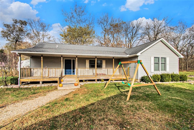 ranch-style home featuring a front lawn and a deck