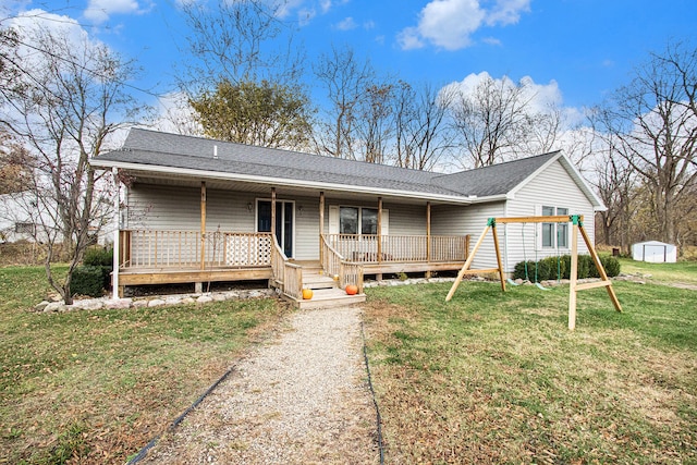 ranch-style house with a porch, a storage unit, and a front lawn