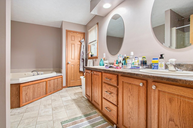 bathroom featuring vanity, independent shower and bath, a textured ceiling, and tile patterned floors