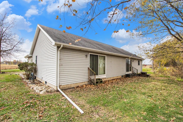 view of property exterior featuring a lawn