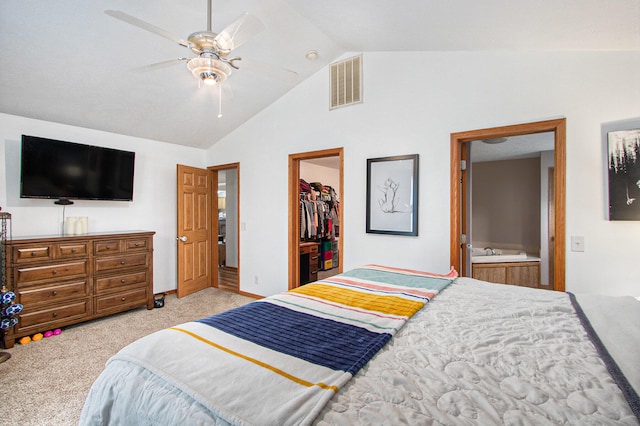 carpeted bedroom with ceiling fan, a spacious closet, vaulted ceiling, ensuite bathroom, and a closet