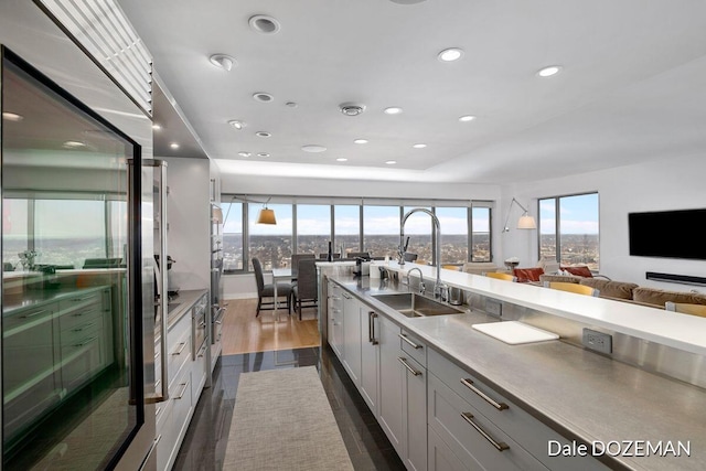 kitchen featuring appliances with stainless steel finishes, sink, white cabinets, and dark hardwood / wood-style floors