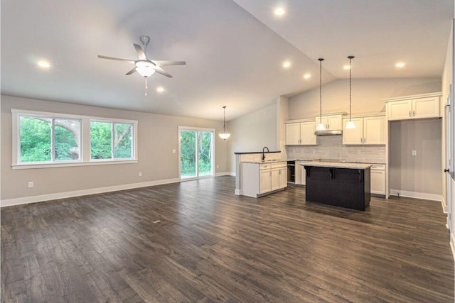 kitchen with a kitchen island, white cabinetry, dark wood-type flooring, pendant lighting, and sink