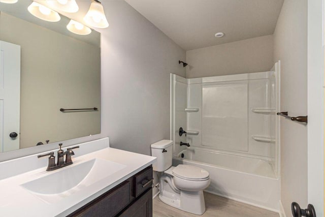 full bathroom with vanity, bathtub / shower combination, hardwood / wood-style floors, and toilet