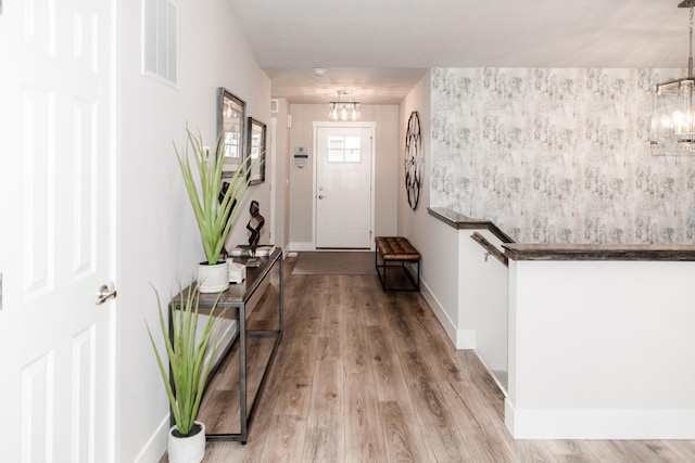 entryway featuring a chandelier and light wood-type flooring