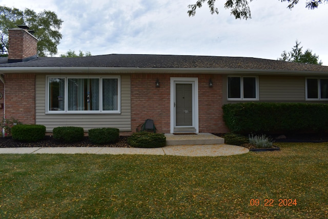 ranch-style house with a front lawn