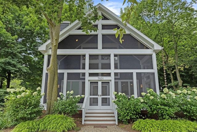 view of outbuilding featuring a sunroom