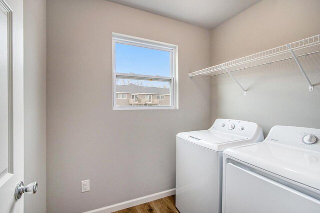 laundry area featuring wood-type flooring and separate washer and dryer