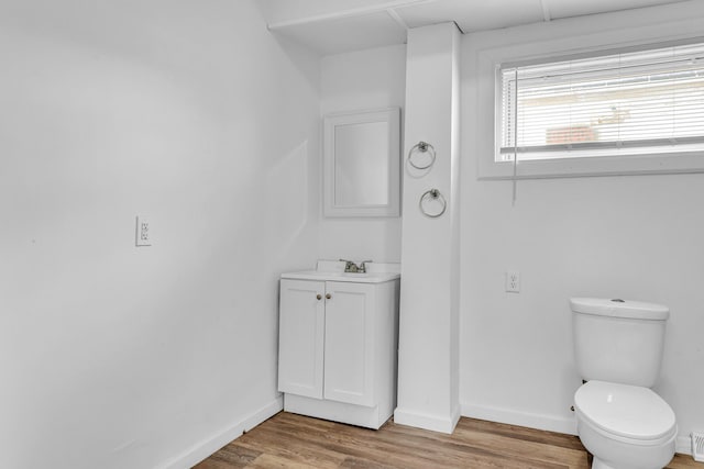 bathroom featuring toilet, hardwood / wood-style flooring, and sink