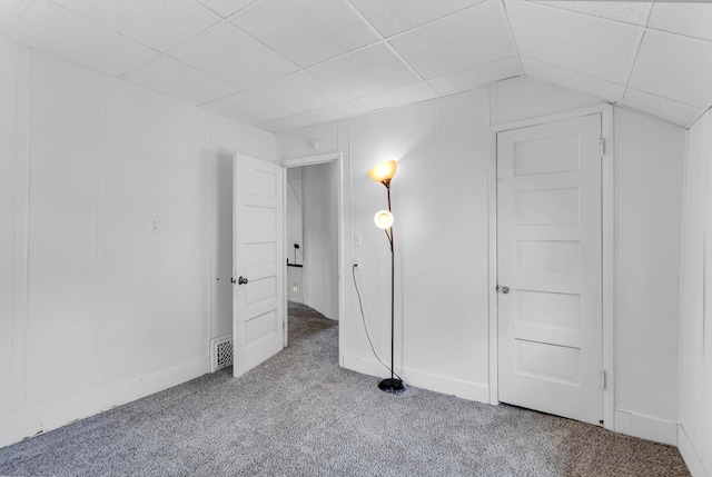 unfurnished bedroom with light carpet, lofted ceiling, and a paneled ceiling