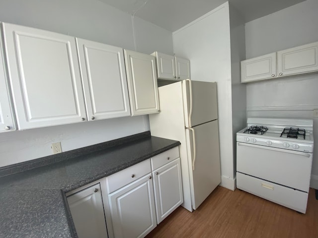 kitchen with white cabinets, dark hardwood / wood-style floors, and white appliances