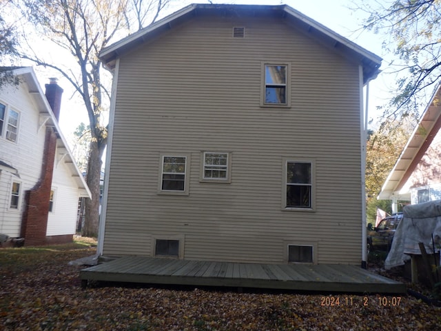 rear view of property featuring a wooden deck