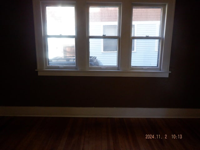 unfurnished room featuring hardwood / wood-style flooring and plenty of natural light