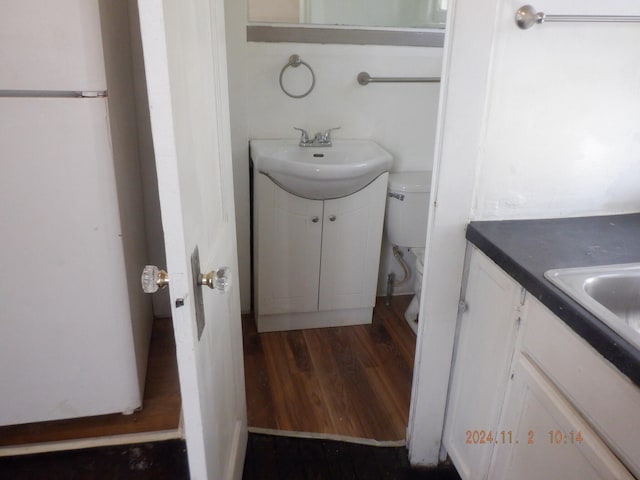 bathroom with vanity, hardwood / wood-style floors, and toilet