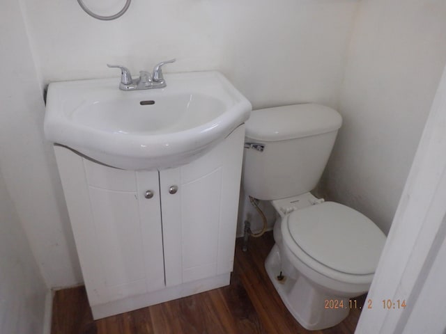 bathroom with vanity, hardwood / wood-style flooring, and toilet