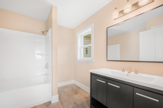 bathroom with vanity and shower / washtub combination