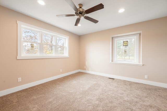 spare room featuring carpet flooring and ceiling fan