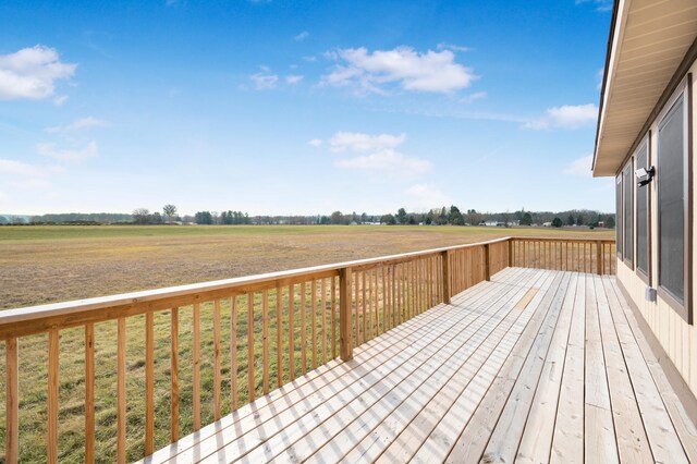 deck featuring a rural view and a yard