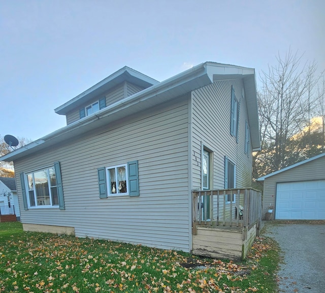 view of side of home with an outdoor structure and a garage