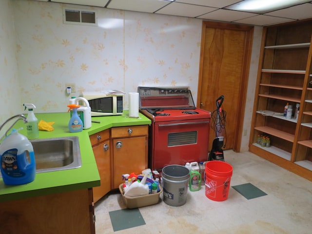 recreation room with a paneled ceiling and sink