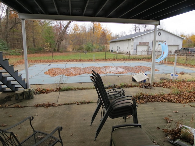 view of patio featuring an outdoor structure and a garage