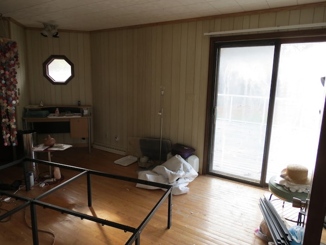 home office featuring wooden walls and light hardwood / wood-style floors