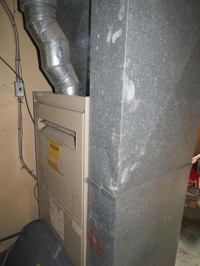 utility room featuring heating unit