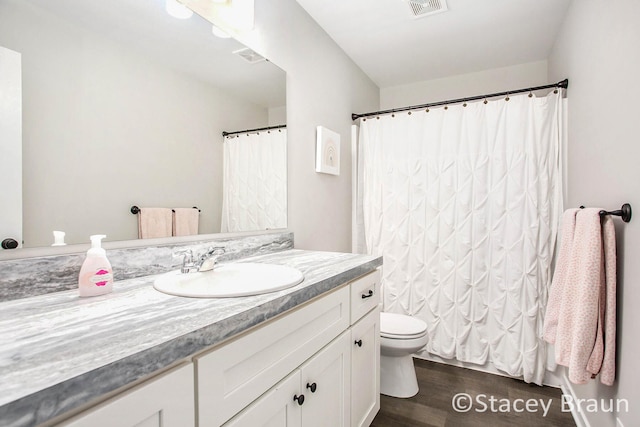 bathroom with hardwood / wood-style floors, vanity, toilet, and a shower with shower curtain