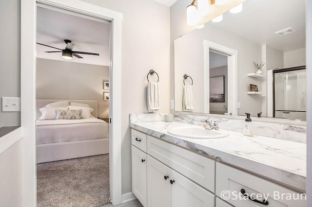 bathroom with vanity, ceiling fan, and a shower with door