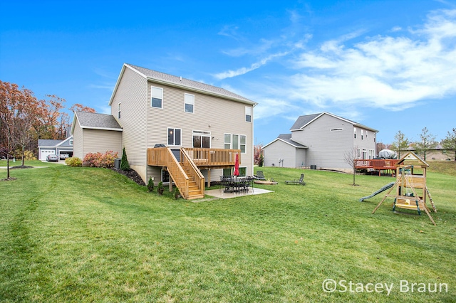 rear view of property featuring cooling unit, a yard, and a deck