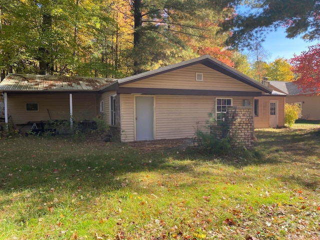 view of side of property with a yard