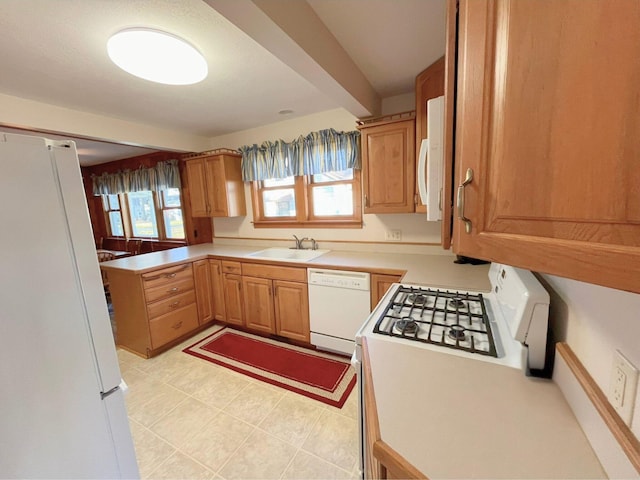 kitchen featuring white appliances and sink