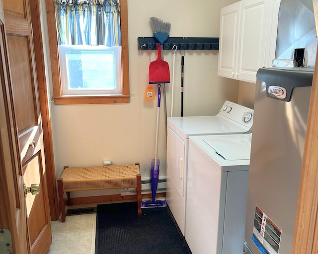 washroom with cabinets, light tile patterned flooring, and washing machine and dryer