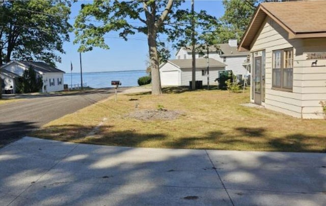 view of yard with a garage and an outbuilding