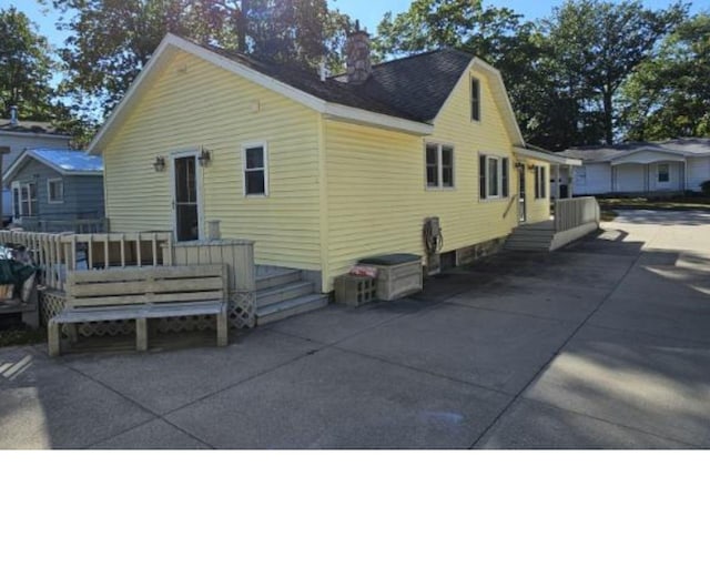 rear view of house with a patio area and a wooden deck