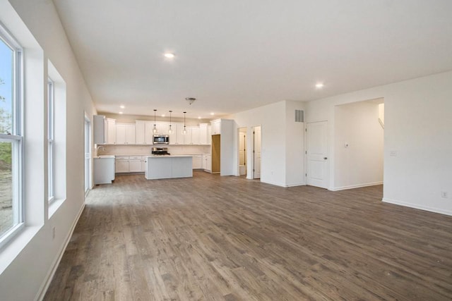 unfurnished living room featuring wood-type flooring