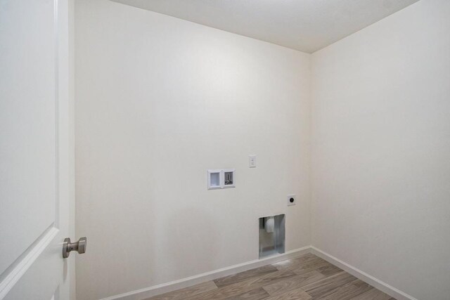 laundry room featuring hookup for an electric dryer, washer hookup, and light hardwood / wood-style floors