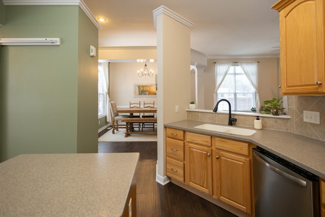 kitchen with dark hardwood / wood-style flooring, tasteful backsplash, stainless steel dishwasher, crown molding, and sink