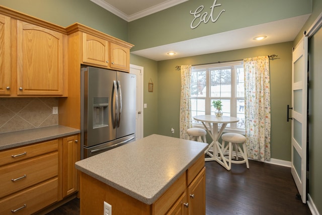 kitchen featuring dark hardwood / wood-style flooring, stainless steel refrigerator with ice dispenser, crown molding, decorative backsplash, and a kitchen island