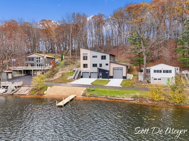 rear view of house with a deck with water view