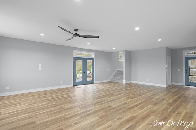 unfurnished living room featuring french doors, ceiling fan, and light hardwood / wood-style flooring