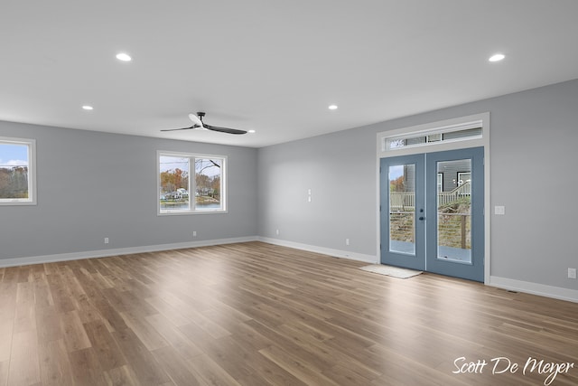 spare room with light wood-type flooring, french doors, and ceiling fan