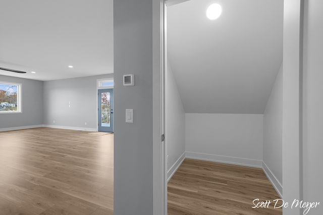 bonus room featuring light wood-type flooring and lofted ceiling