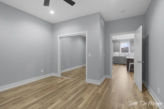 unfurnished bedroom featuring a closet, ceiling fan, and light hardwood / wood-style floors