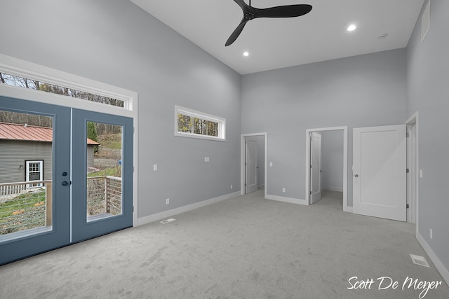 interior space featuring ceiling fan, high vaulted ceiling, light colored carpet, french doors, and access to outside