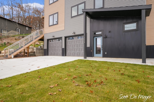 exterior space featuring a garage and a lawn